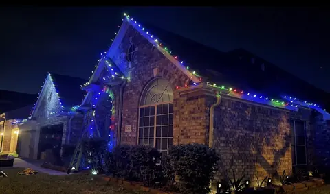 Multicolor C9 lights on a brick home at night