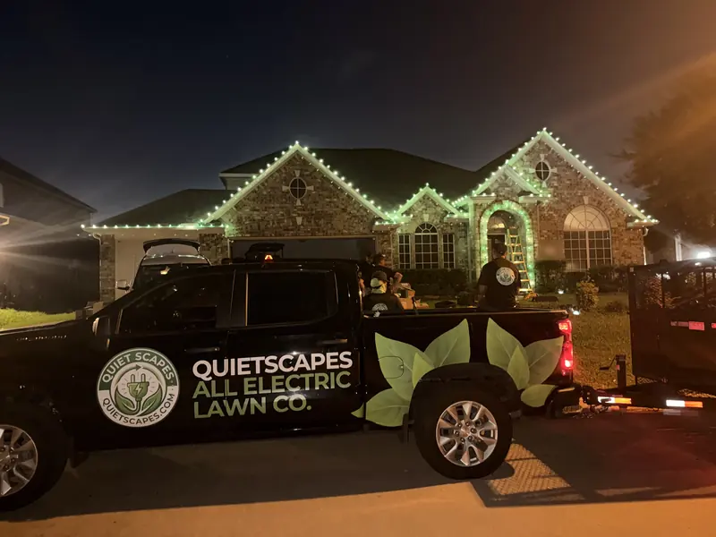 QuietScapes truck parked outside while the crew installs green C9 lights